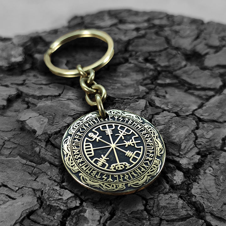 Macro photo of a brass coin keychain with deep-etched Vegvisir and protective antique patina, personalized nordic protection gift for travelers.