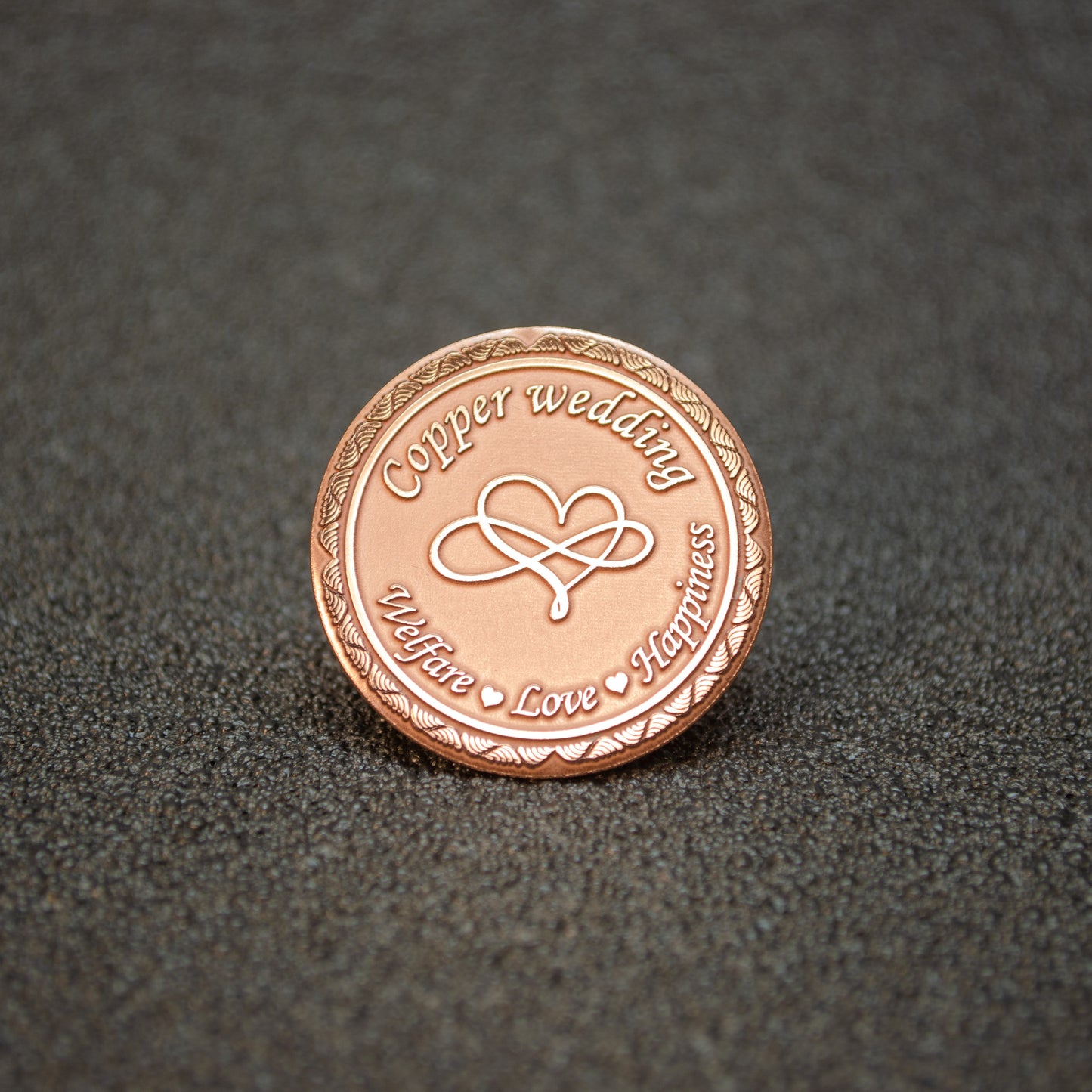 Pure copper 7th anniversary souvenir coin, personalized metal gift with infinity heart design and decorative border, obverse view.