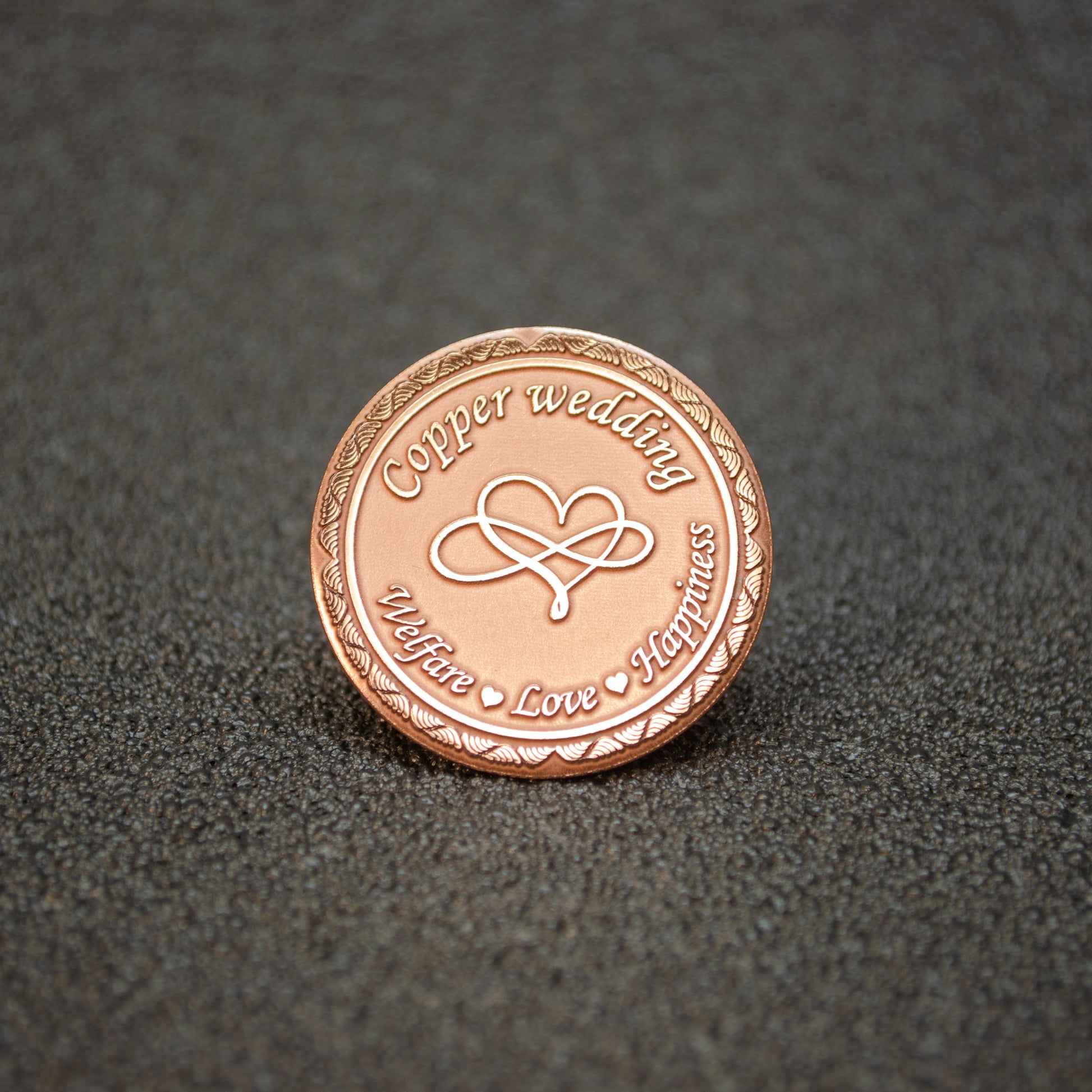 Pure copper 7th anniversary souvenir coin, personalized metal gift with infinity heart design and decorative border, obverse view.