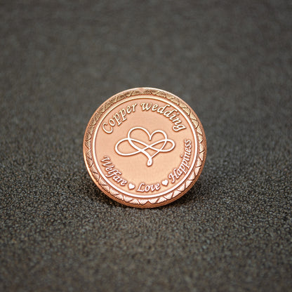 Pure copper 7th anniversary souvenir coin, personalized metal gift with infinity heart design and decorative border, obverse view.