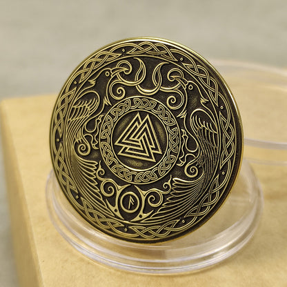 Top view of a Norse Valknut amulet coin in brass, detailed Scandinavian knotwork engraving with high-contrast finish.