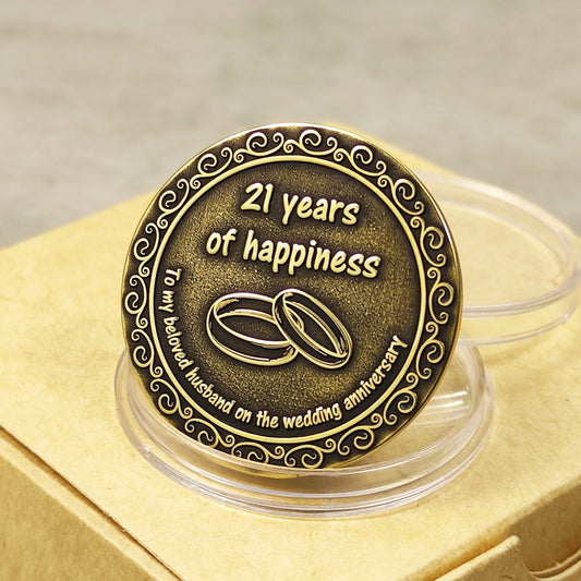 Reverse side of personalized brass wedding anniversary coin for husband with "21 years of happiness" engraving and vintage patina finish.