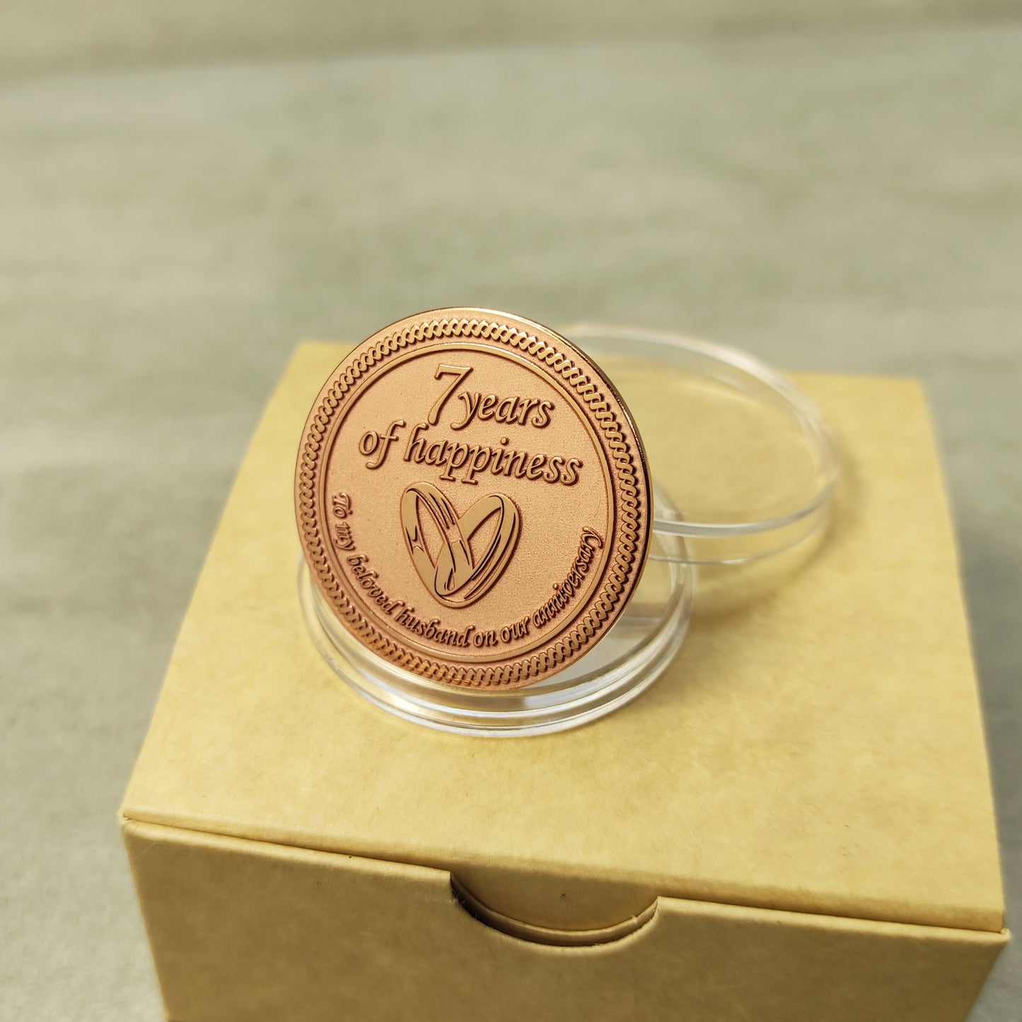 Pure copper 7th anniversary souvenir coin, personalized metal gift with decorative border and glossy polished surface.