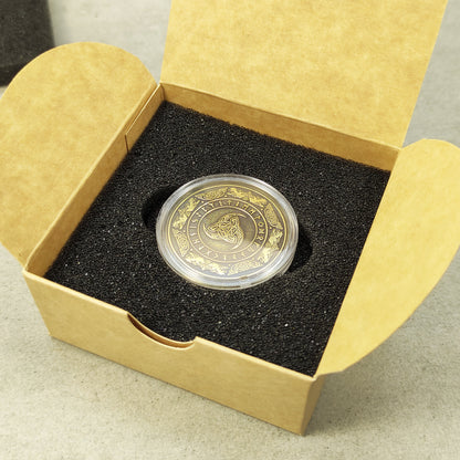 Personalized brass souvenir coin in a protective acrylic capsule and craft gift box, premium presentation of a Norse mythology gift.
