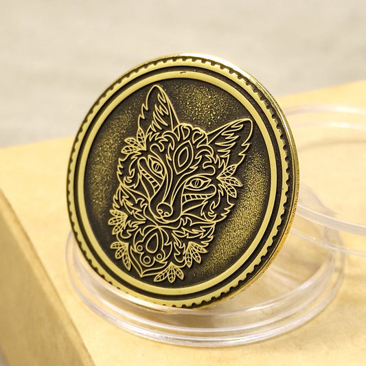 Close-up of a brass coin with ornate fox head engraving, featuring dark patina and textured background in a protective capsule.