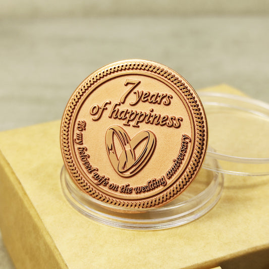 7th wedding anniversary copper coin for wife, "7 years of happiness" engraved token with wedding rings, polished finish.