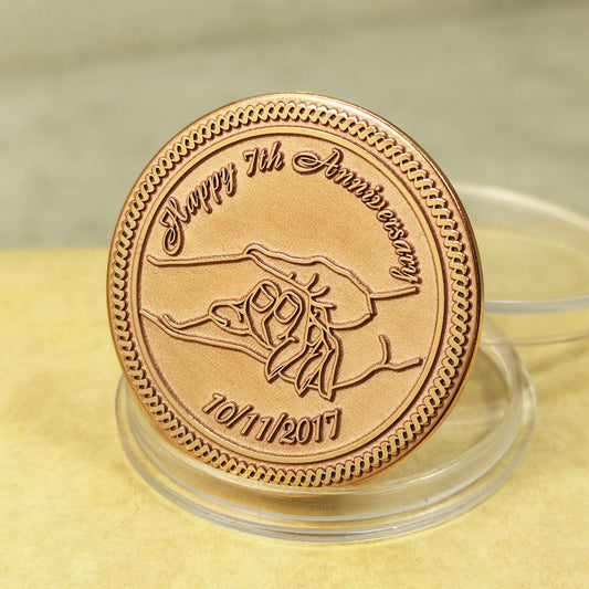7th wedding anniversary copper coin with deep engraving of holding hands, "Happy 7th Anniversary" personalized gift, polished copper finish.