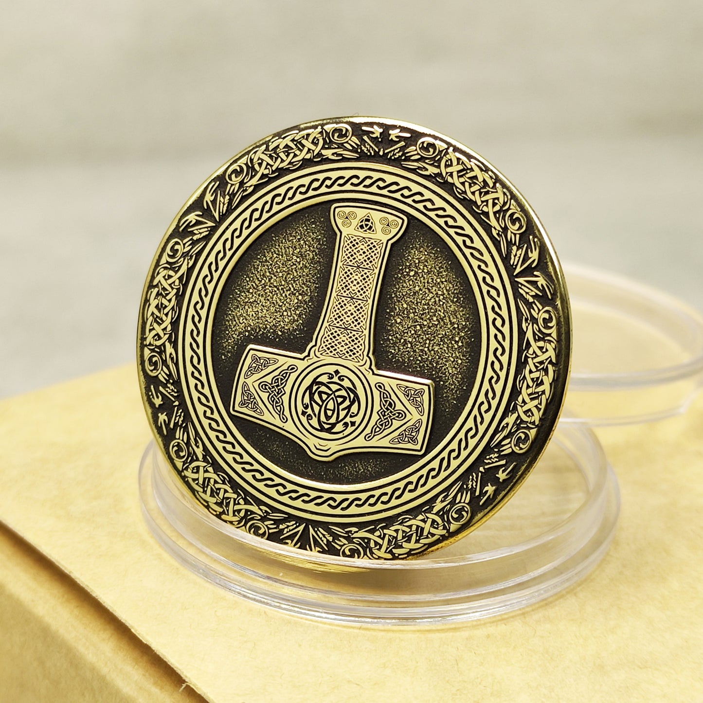 Brass coin Thor's Hammer Mjolnir with 3D embossed design and antique patina finish.