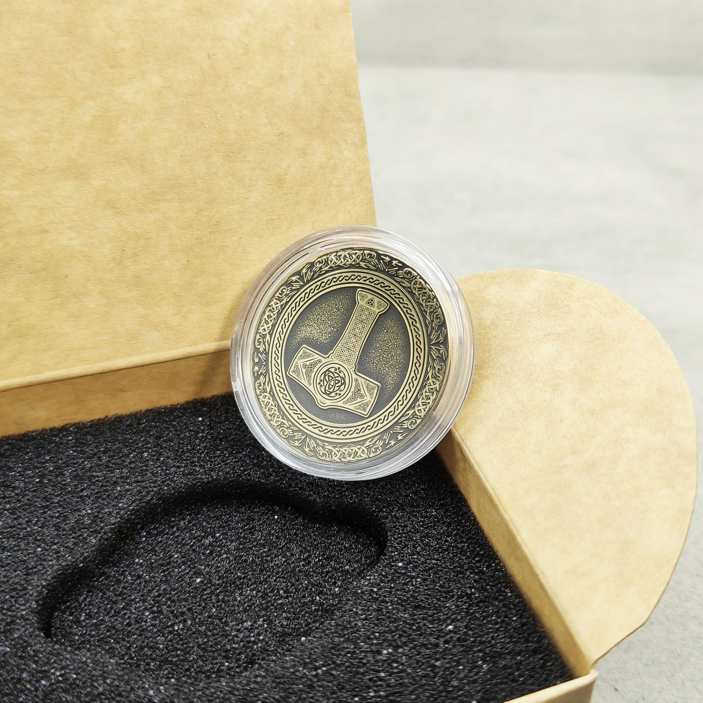 Reverse side of the brass coin with engraved Strength, Courage, and Protection text.