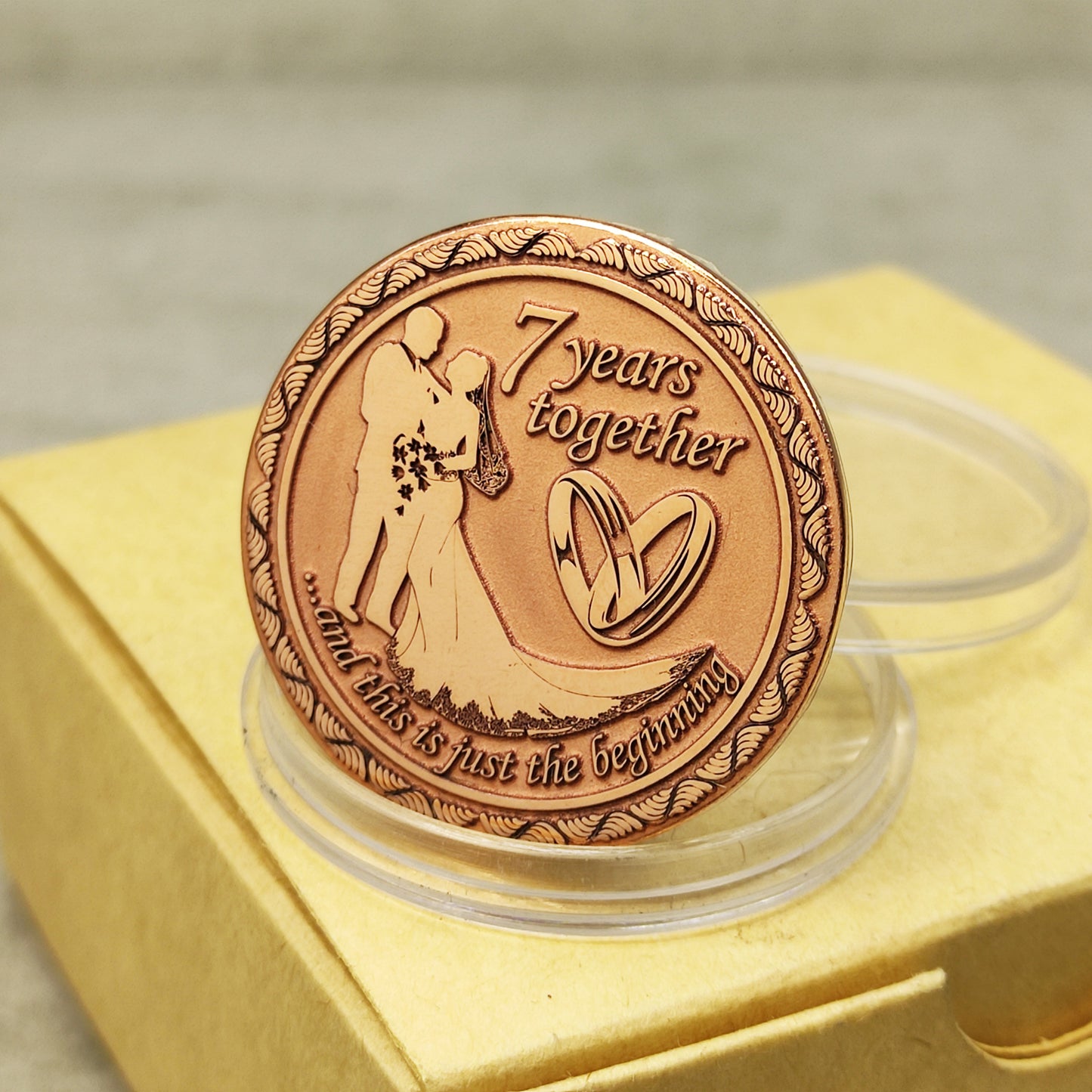 7th wedding anniversary copper coin with deep engraving of a couple and rings, "7 years together" personalized gift, polished copper finish.