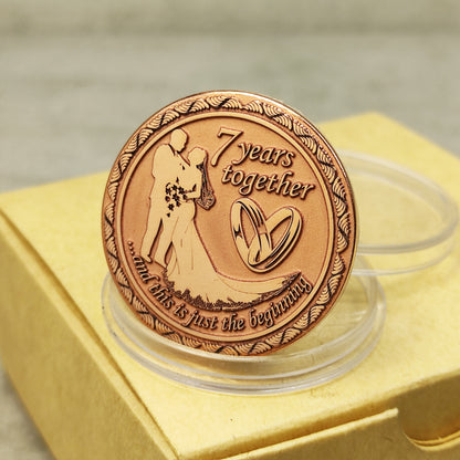 7th wedding anniversary copper coin with deep engraving of a couple and rings, "7 years together" personalized gift, polished copper finish.