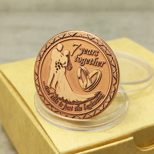 7th wedding anniversary copper coin with deep engraving of a couple and rings, "7 years together" personalized gift, polished copper finish.