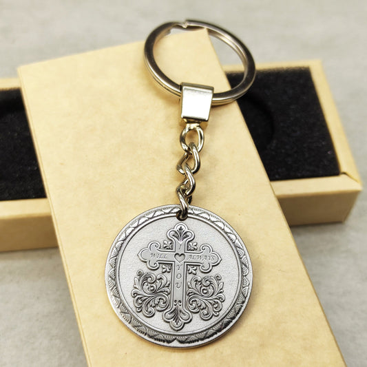 Personalized stainless steel coin keychain with deep laser engraved ornate cross design.