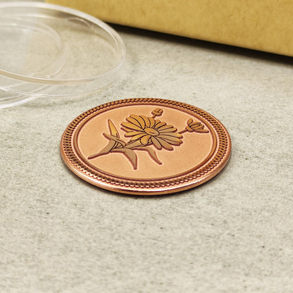 Flat lay of the copper Daisy coin on a neutral background, highlighting the uniform material quality and intricate details of the engraved petals.
