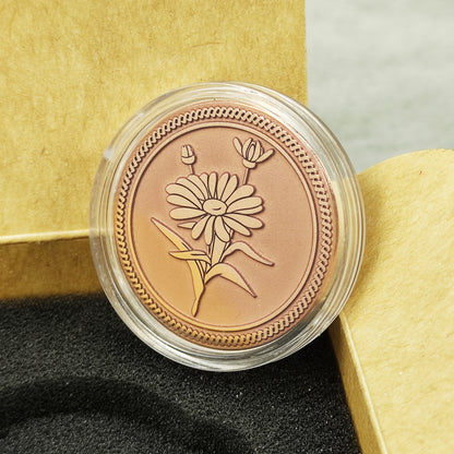 Macro photo of the floral copper coin inside a protective clear acrylic capsule, ensuring the preservation of the matte copper finish.