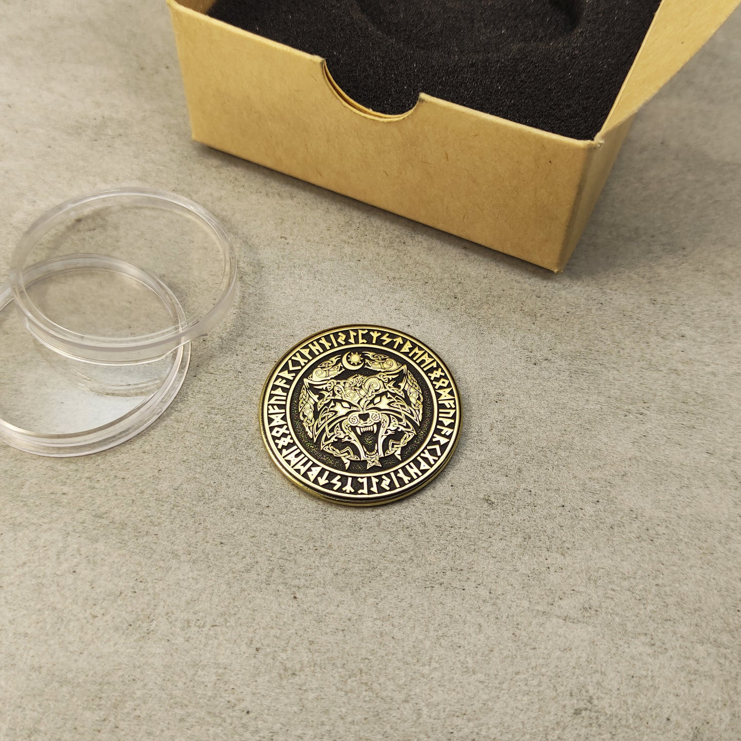 Perspective view of a 2mm thick brass challenge coin, showcasing the golden luster and precision of the Viking wolf design.