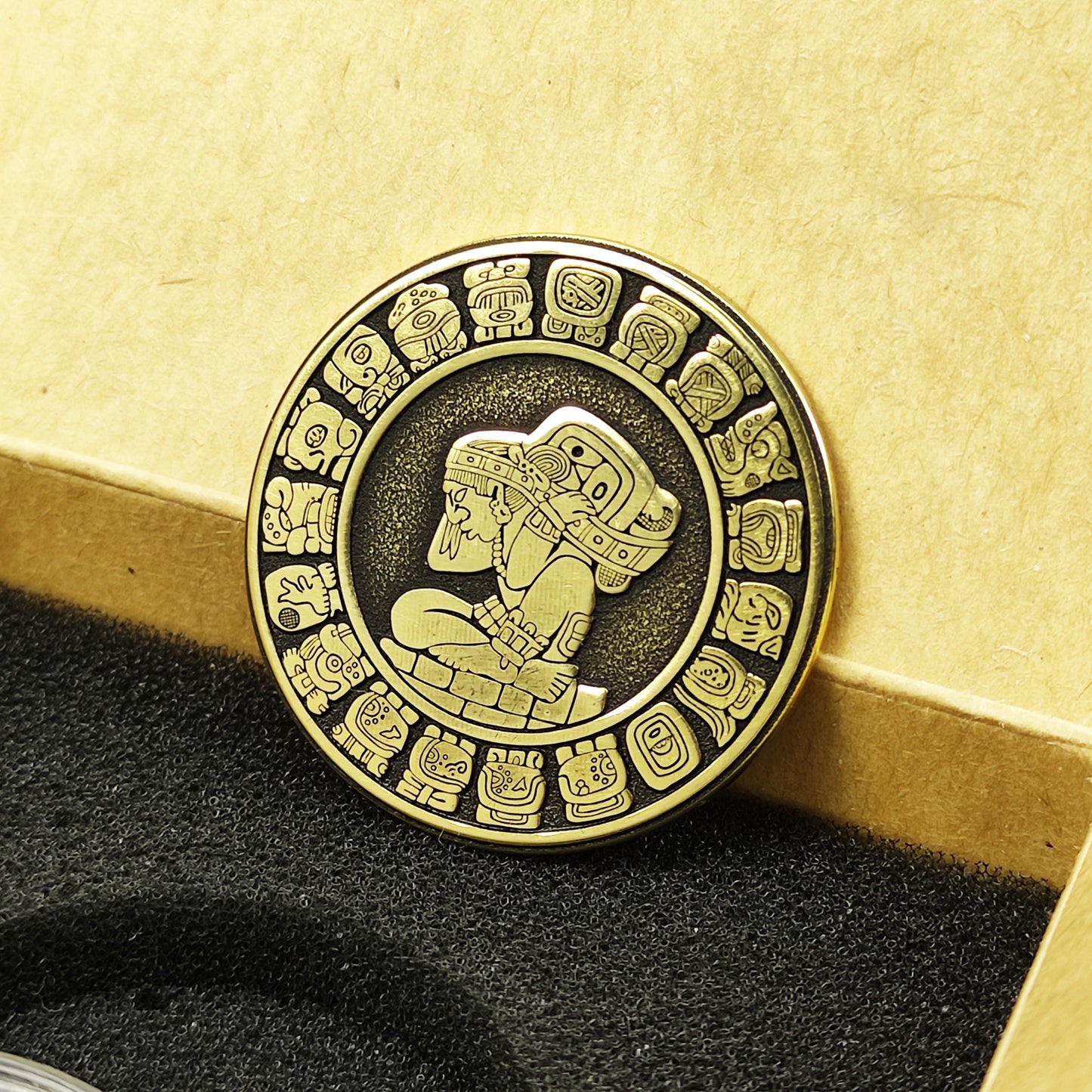 Custom engraved Mayan calendar brass coin in a premium gift box, authentic spiritual talisman with traditional glyphs.