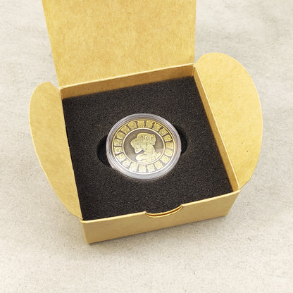 Personalized brass Mayan calendar coin in a black foam insert inside a craft box, premium quality handcrafted gift set.