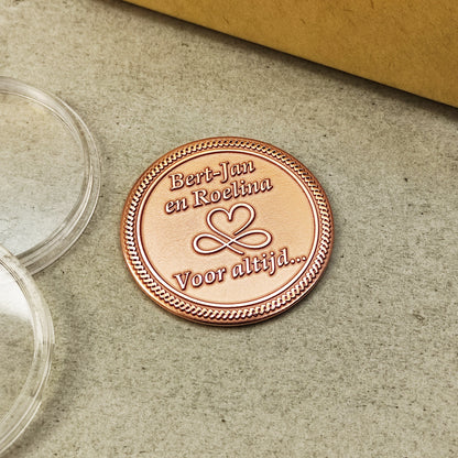 Top view of a custom copper coin with personalized text, showing the uniform material quality and decorative rope border detail.