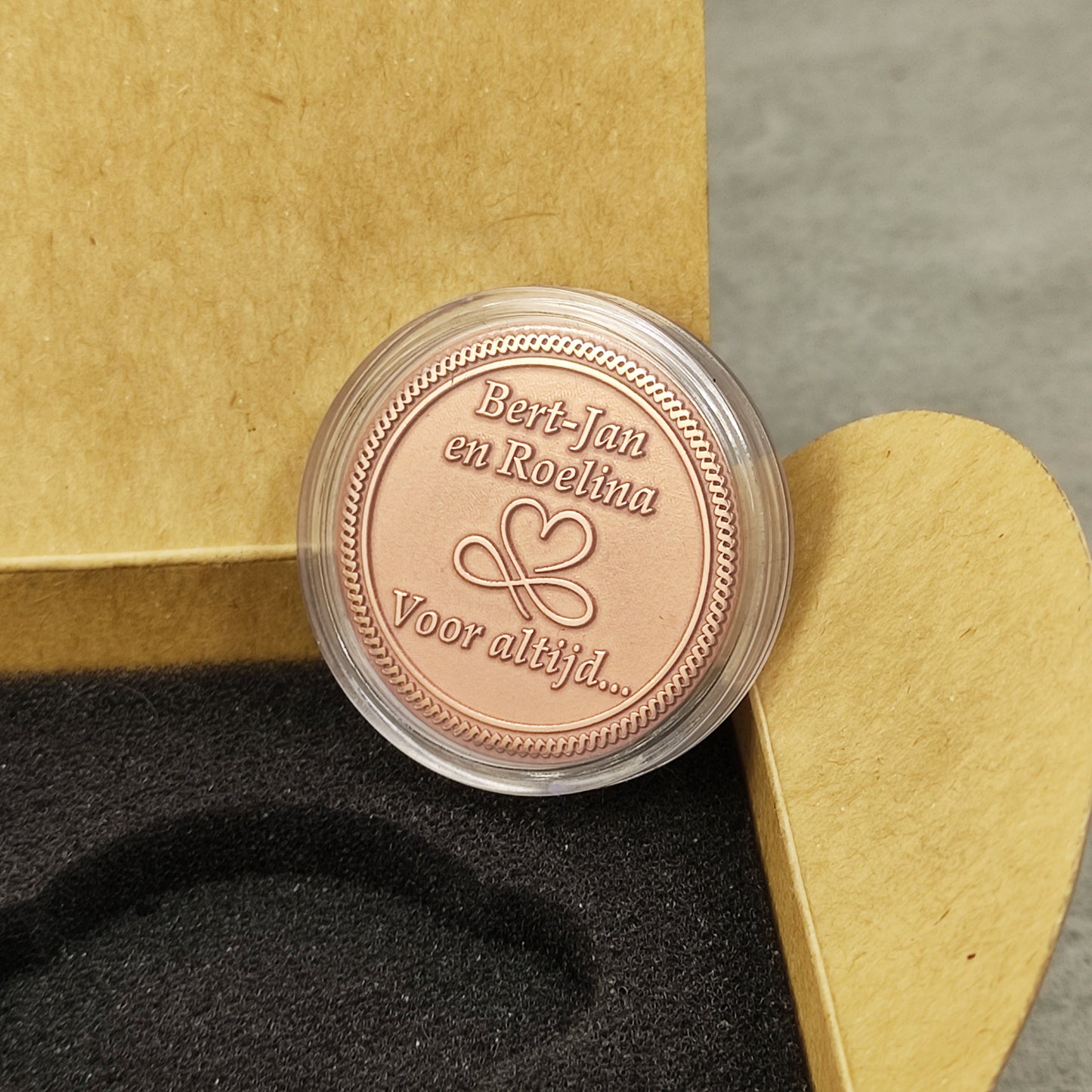 Macro photo of a personalized copper souvenir in a protective acrylic capsule, ensuring the preservation of the polished copper finish.