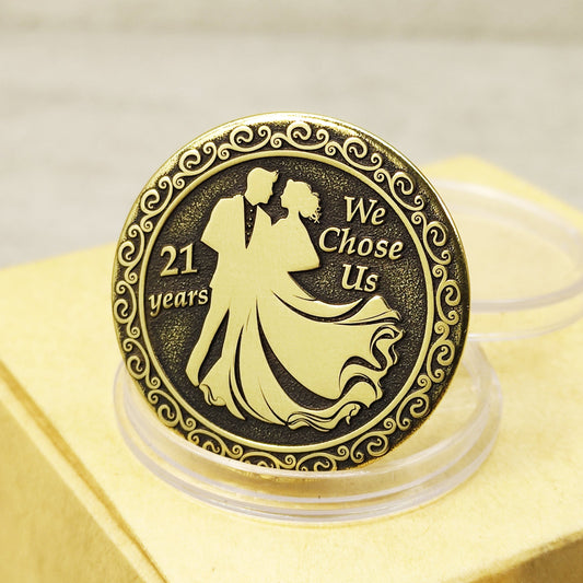 Brass 21st wedding anniversary coin with deep engraving of a couple and "We Chose Us" text, vintage patina finish.