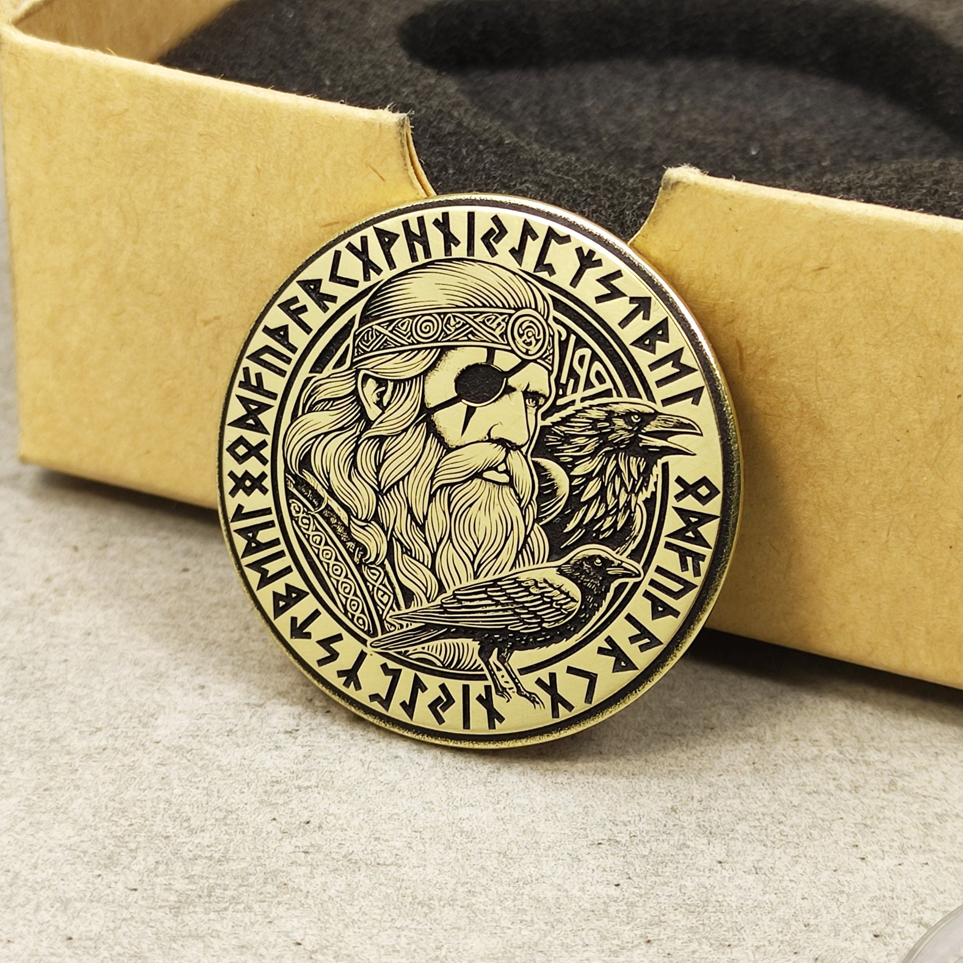 Handcrafted Odin brass amulet in a premium gift box, detailed Viking god engraving with Elder Futhark rune circle.