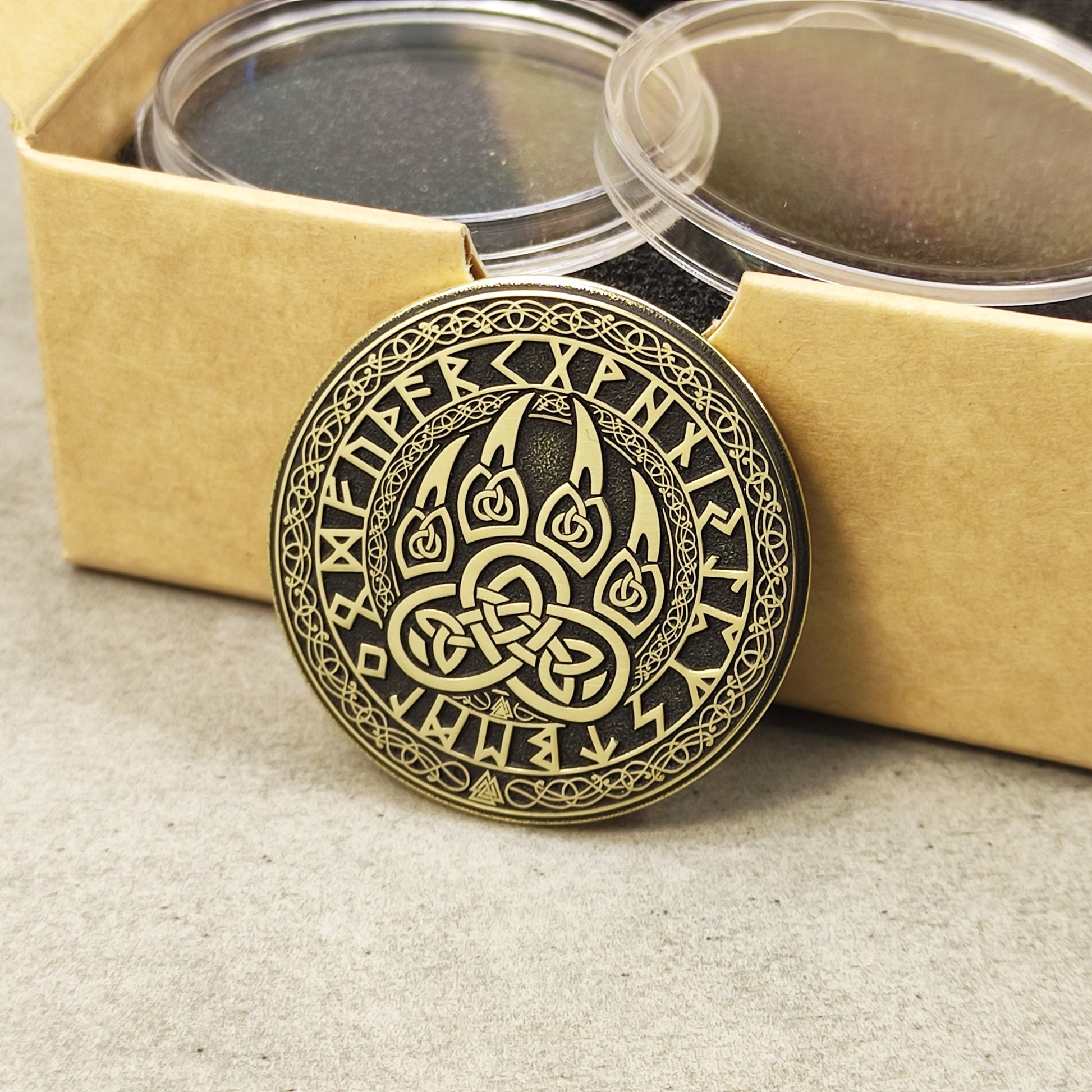 Side view of the Viking bear paw brass coin showing deep relief laser engraving.