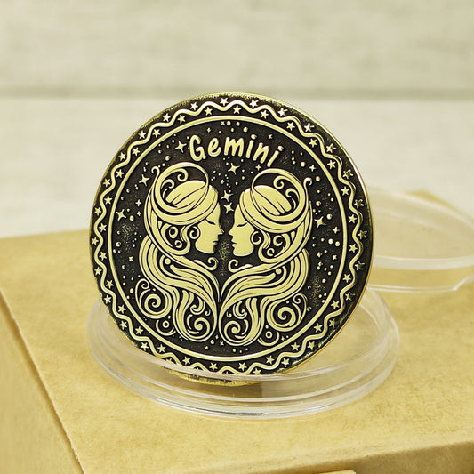 Close-up of Gemini zodiac brass medal with deep laser engraving of two female profiles, features antique dark patina finish and decorative celestial border.