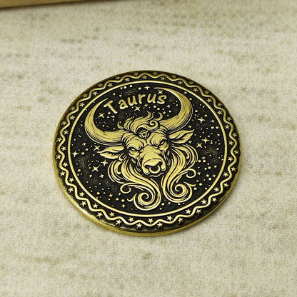 Detailed view of the Taurus zodiac brass medal, highlighting the intricate 3D-style engraving and dark recessed patina on the polished brass surface.