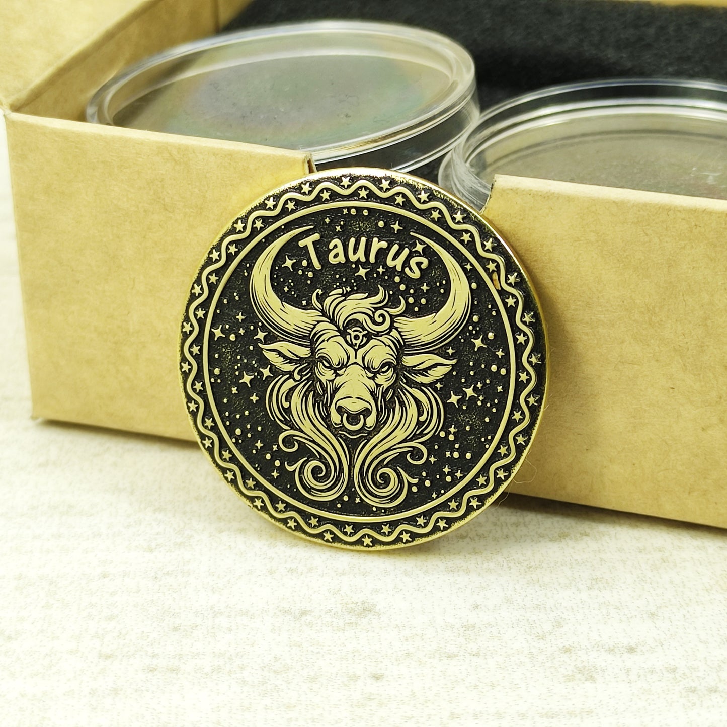 Taurus zodiac brass medal presented with minimalist gift packaging, showcasing the 32mm diameter and premium metal quality of the custom engraved coin.