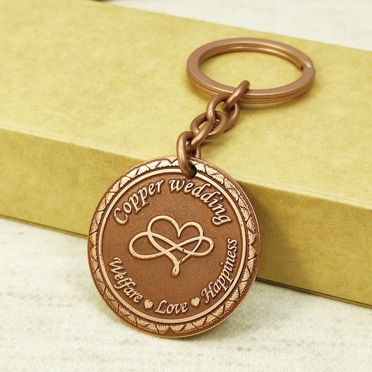 7th wedding anniversary copper coin keychain with deep engraved infinity heart and antique patina finish.