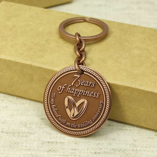 7th wedding anniversary copper keychain for wife, "7 years of happiness" engraved coin gift with wedding rings, antique copper finish.