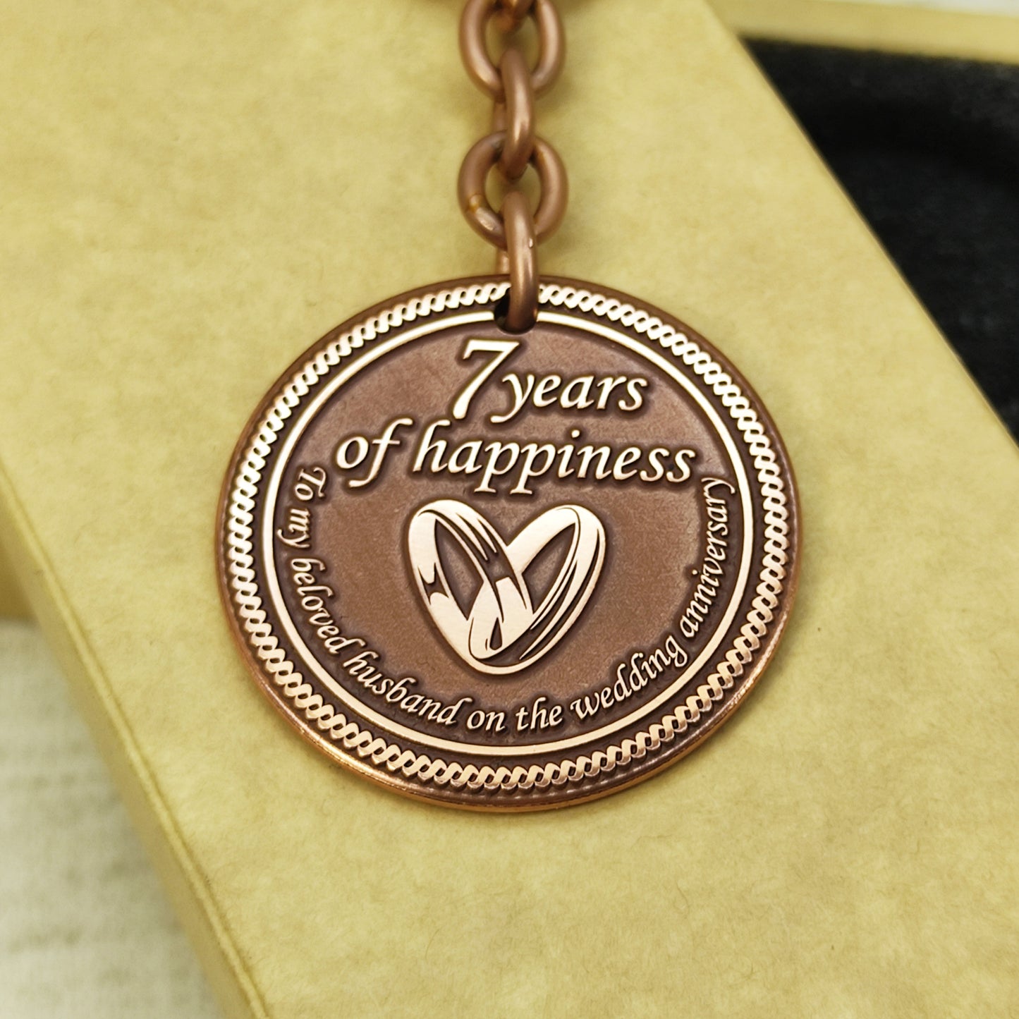 Engraved copper keychain coin for 7 years of marriage celebration, personalized gift for him with sturdy metal ring and antique finish.