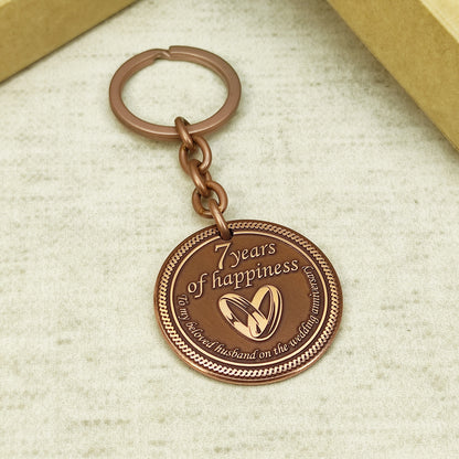 Hand-polished copper anniversary keychain with "To my beloved husband" text, personalized wedding date engraving, high-quality metalwork.