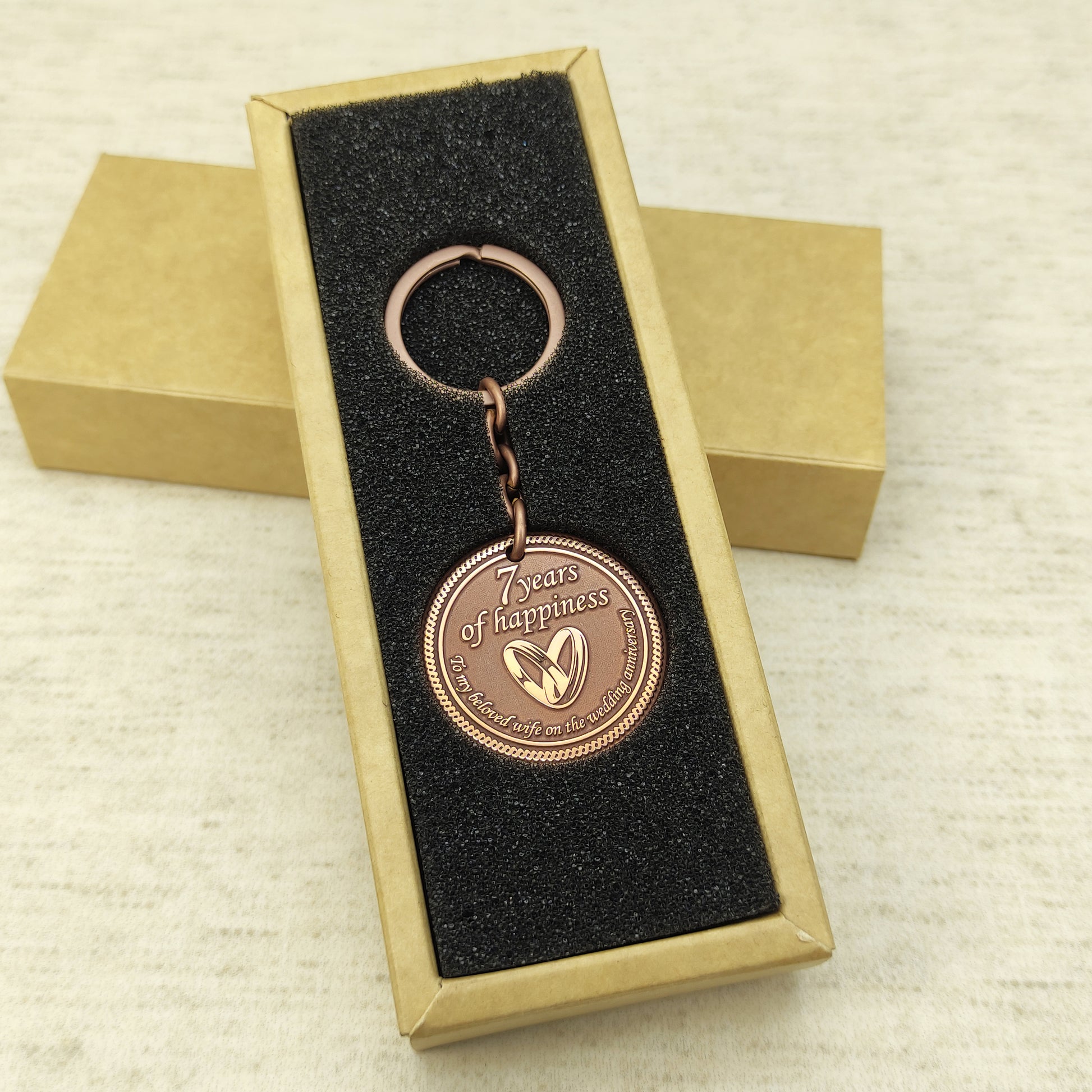 Personalized 7th anniversary copper keychain for wife inside a premium gift box, ready to gift handmade souvenir with custom engraving.