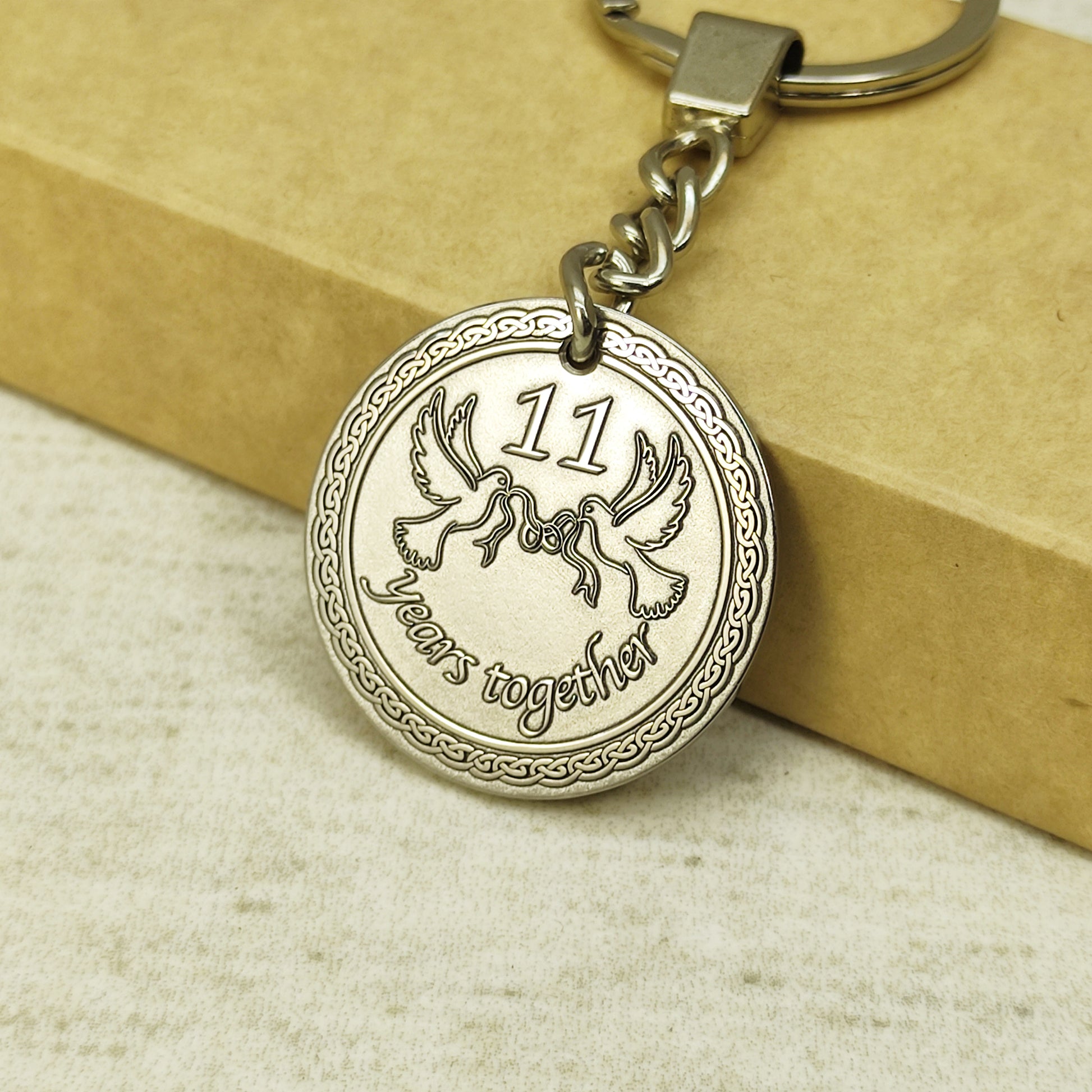 Detailed view of 11th wedding anniversary steel medallion showing intricate laser engraved patterns.
