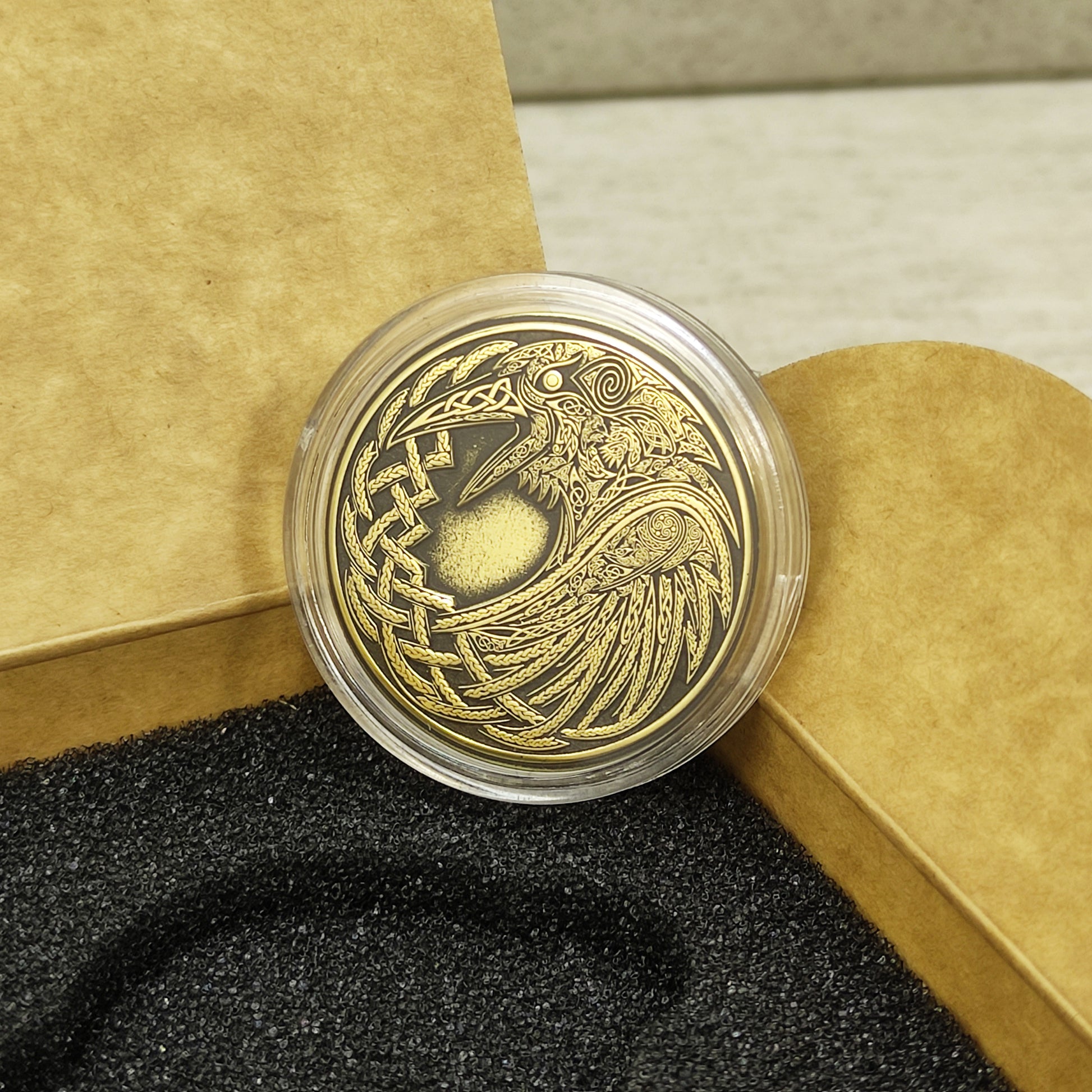 Back view of a brass souvenir coin in an acrylic capsule, smooth surface ready for personalized custom laser engraving.
