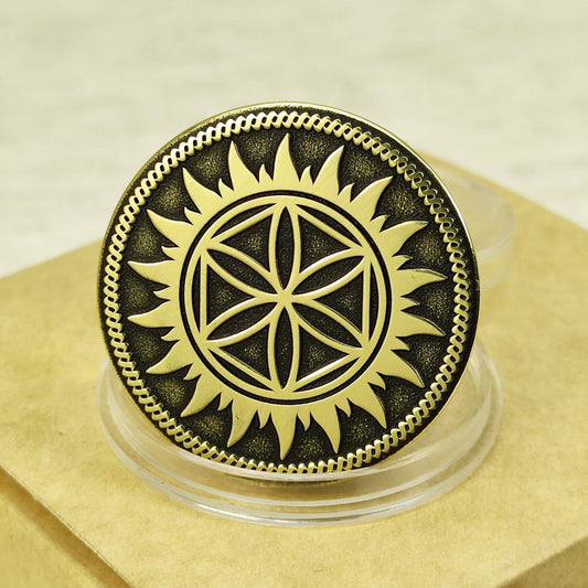 Close-up of personalized brass Perun Star coin with deep engraving and dark patina finish on a clear stand.