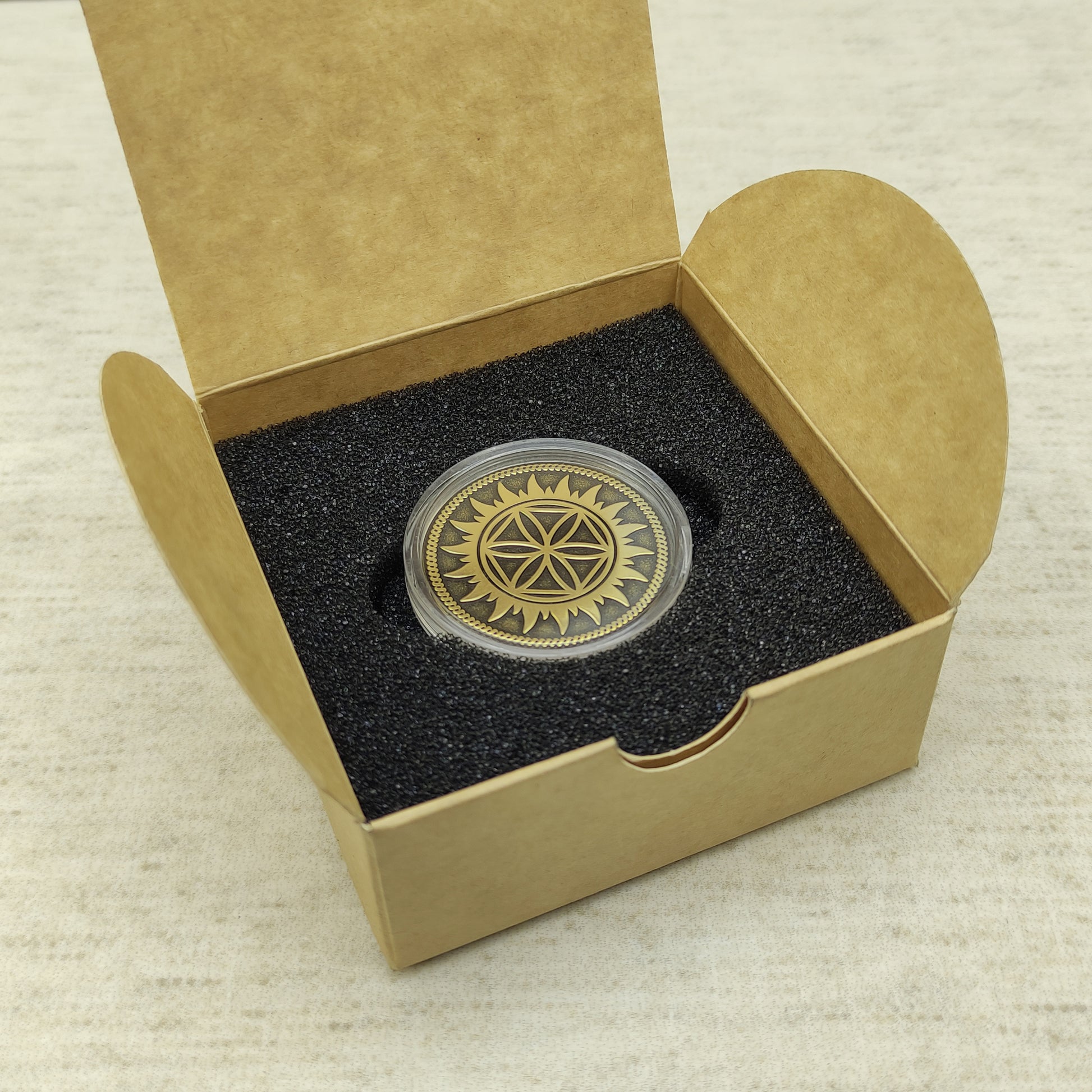 Brass Perun Star custom coin in protective capsule and eco-friendly cardboard gift packaging for a unique present.