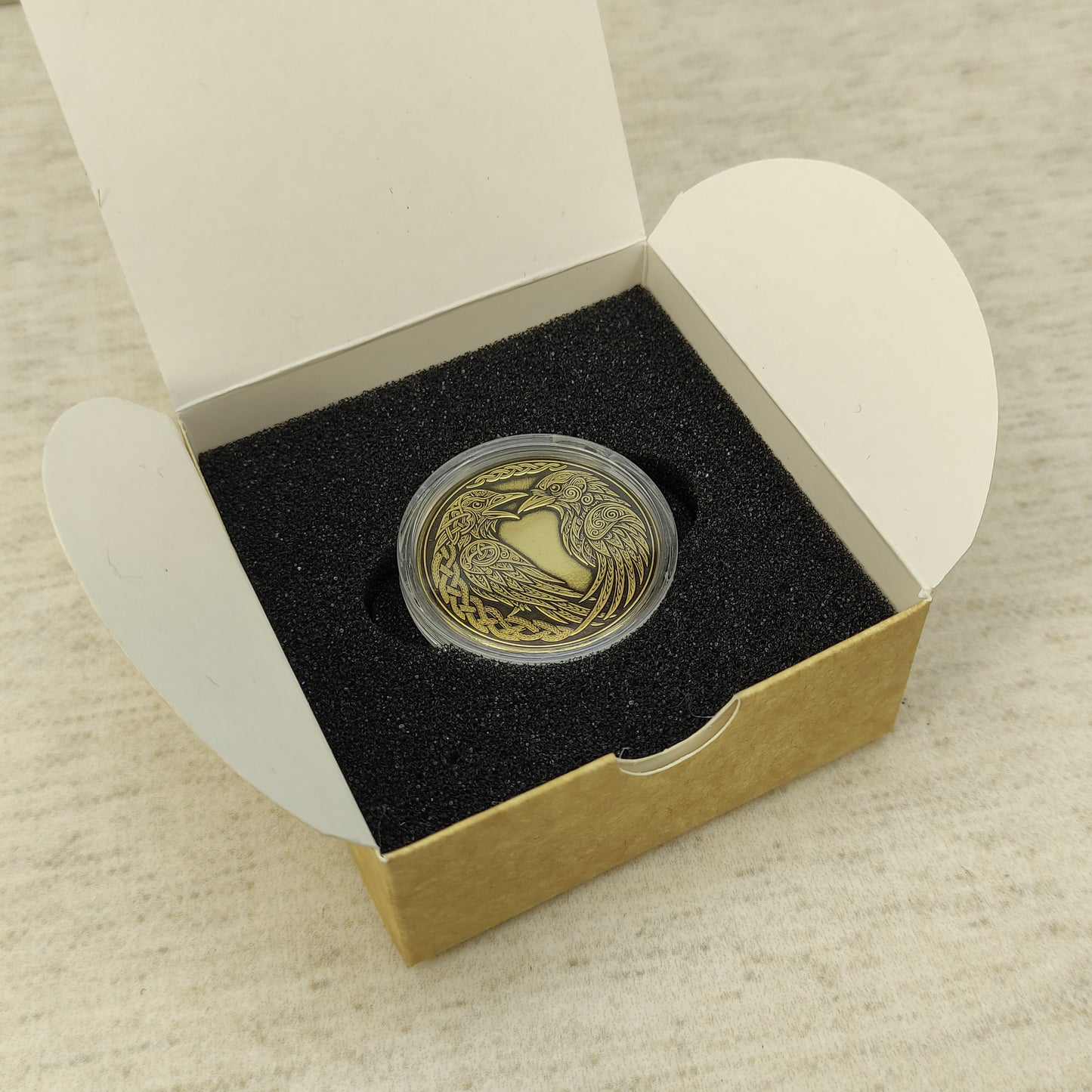 Personalized brass Odin's ravens souvenir in a black foam insert inside a craft gift box, premium handcrafted gift presentation.