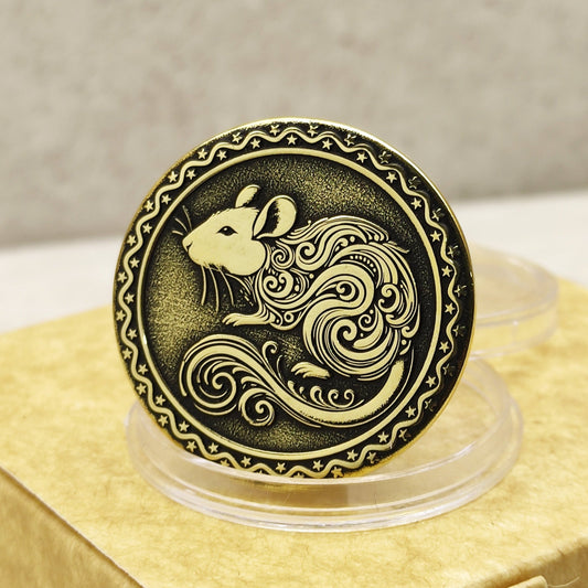 Close-up of a brass Chinese zodiac coin Year of the Rat, featuring deep laser engraving, antique patina finish, and decorative border on a gift box.