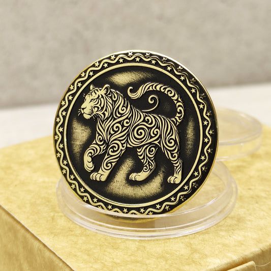 Close-up of a brass Chinese zodiac coin Year of the Tiger, featuring deep laser engraving, antique patina finish, and decorative star border on a gift box.
