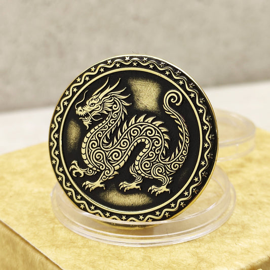 Close-up of a brass Chinese zodiac coin Year of the Dragon, featuring deep laser engraving, antique patina finish, and decorative star border on a gift box.