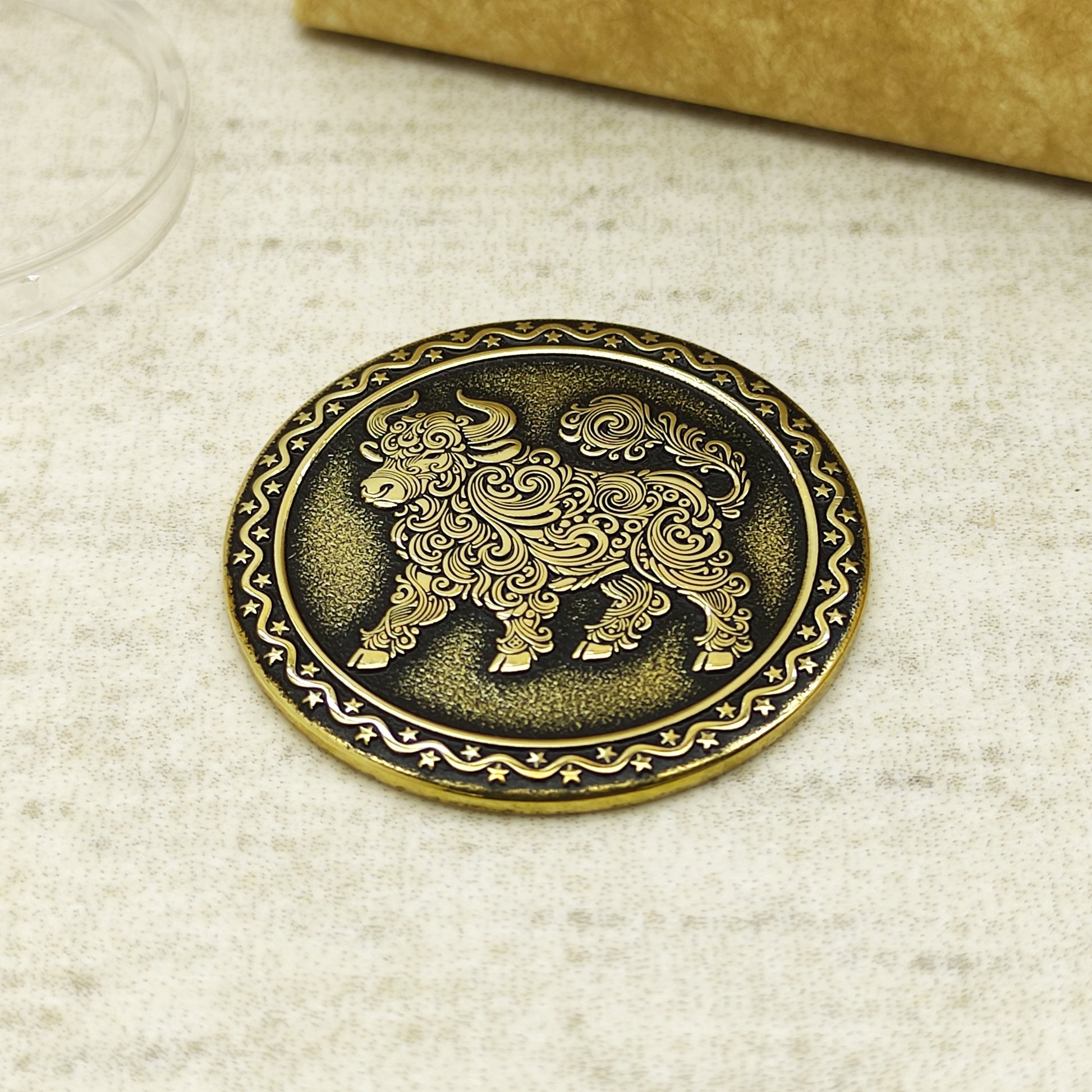 Detailed view of the brass Ox zodiac coin with 3D-style floral patterns, showcasing the 32mm diameter and professional deep laser etching.