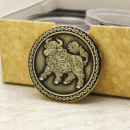 Brass Year of the Ox zodiac coin in a protective acrylic capsule and eco-friendly craft gift box, highlighting the polished brass quality.