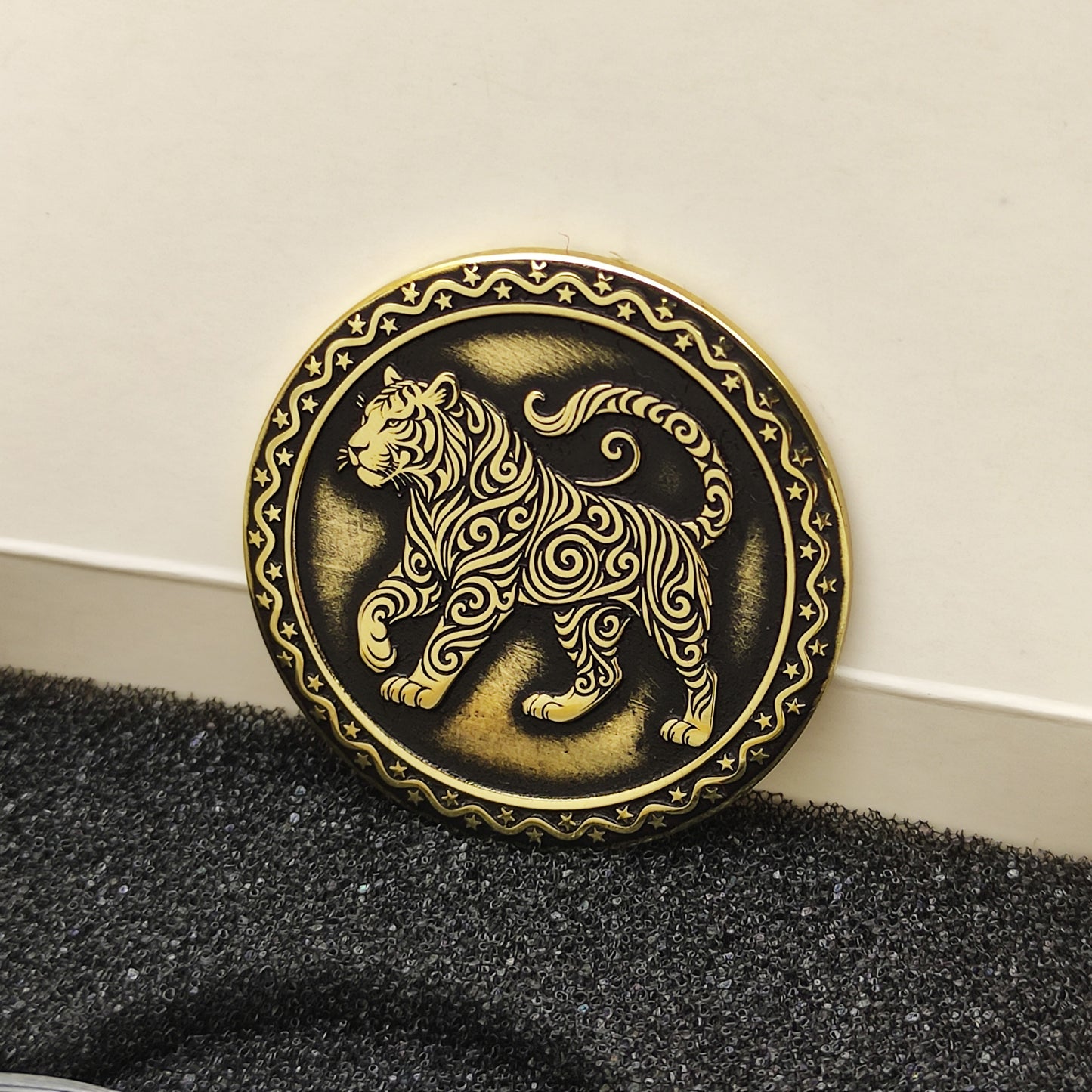 Vertical view of the personalized brass zodiac medal in a premium black insert box, showcasing the antique finish and engraved zodiac details.