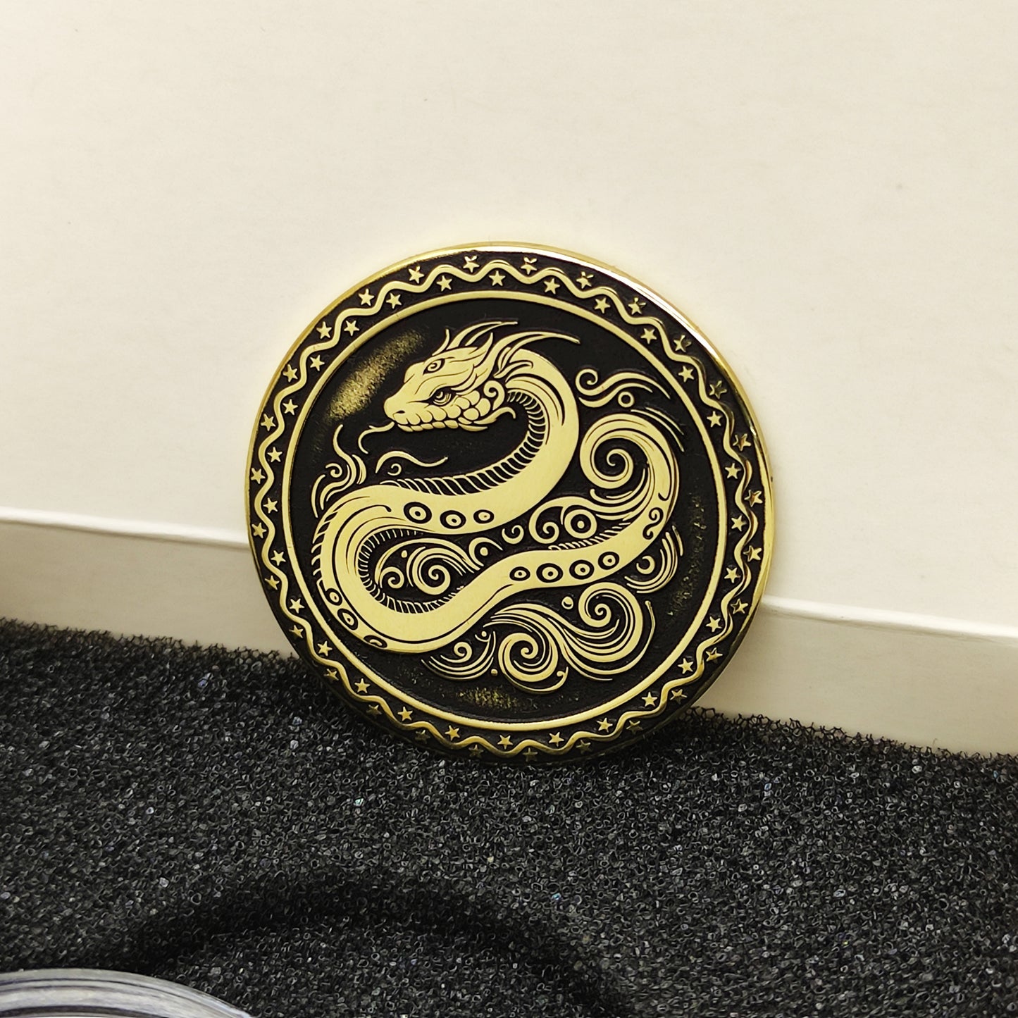 Vertical view of the personalized brass zodiac medal in a premium black insert box, showcasing the antique finish and engraved zodiac details.