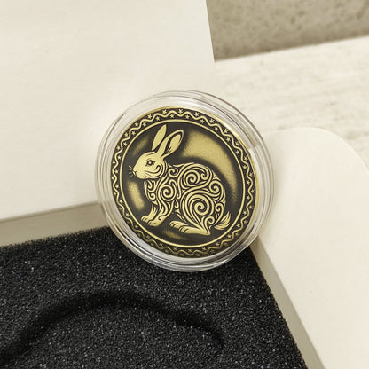 Macro photo of the brass Rabbit coin in a protective capsule, highlighting the intricate dark recessed patina engraving for high contrast.