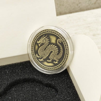 Macro photo of the brass Dragon coin in a protective capsule, highlighting the intricate dark recessed patina engraving for high contrast.