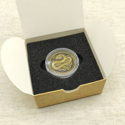 Ready-to-gift personalized brass zodiac medal, handmade Chinese Year of the Snake coin in a square craft box with black foam insert.